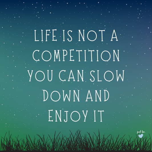 Handwritten quote over a night sky with stars reads Life is not a competition you can slow down and enjoy it.