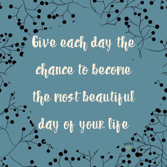 A digital graphic with a blue background and black botanical accents. The quote reads, "Give each day the chance to become the most beautiful day of your life."
