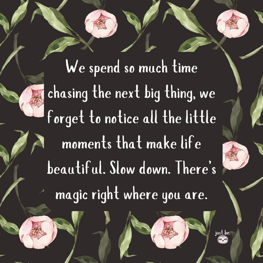 A dark floral background with pink flowers and green leaves, featuring a quote that reminds us to slow down and appreciate the little moments that make life beautiful.